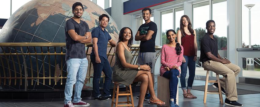 International Students in front of the Waterman Globe in the Mitchell Center